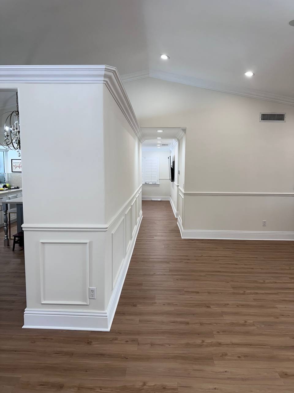 Sunny Isles home hallway with new flooring and detailed wall trim