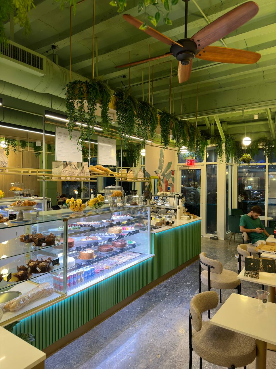 Completed Vanilla Cafe interior with pastry displays and green service counter