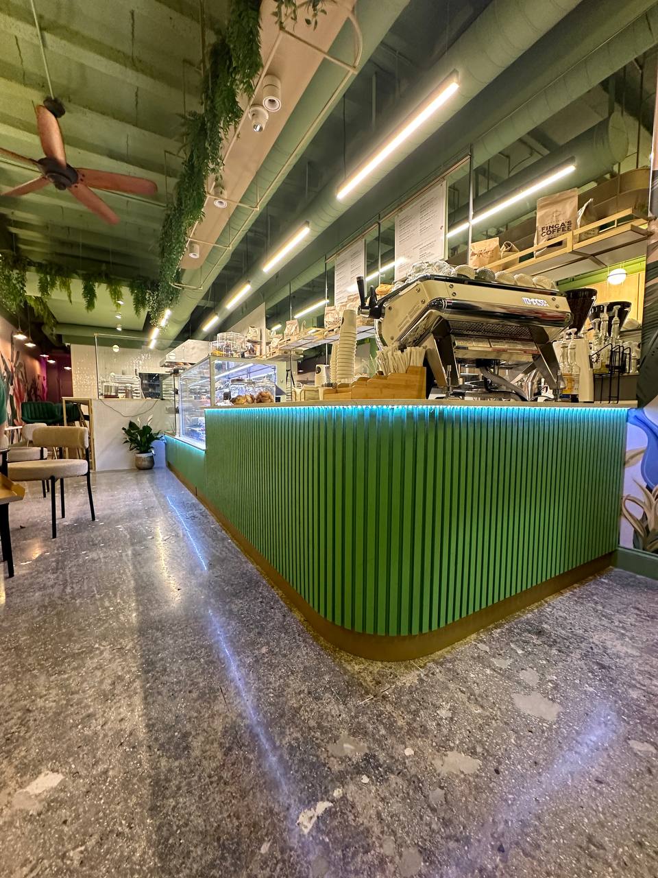 Custom green service counter and coffee equipment at Vanilla Cafe
